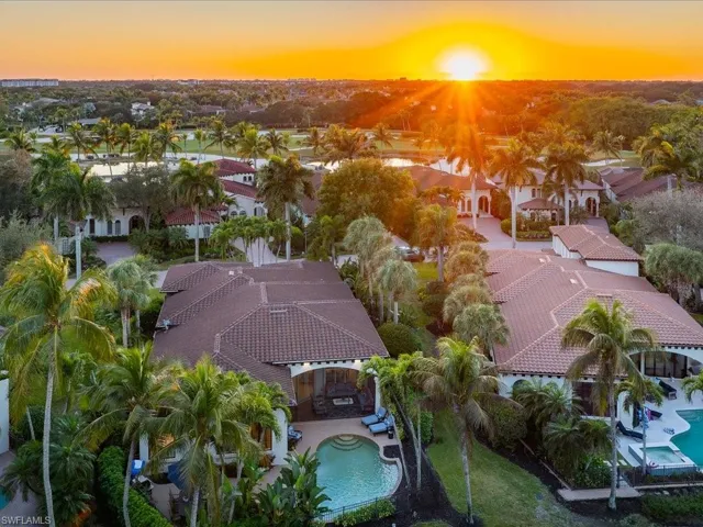 Aerial view at dusk of view of pool and a residential view
