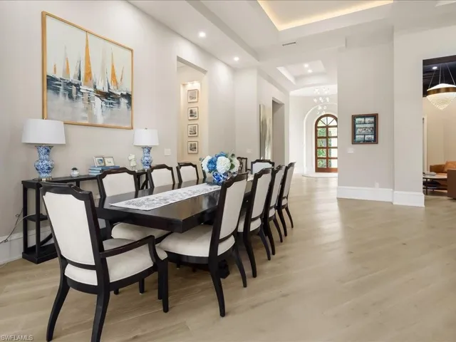 Living area featuring European White Oak wood flooring, and dramatic ceiling details.