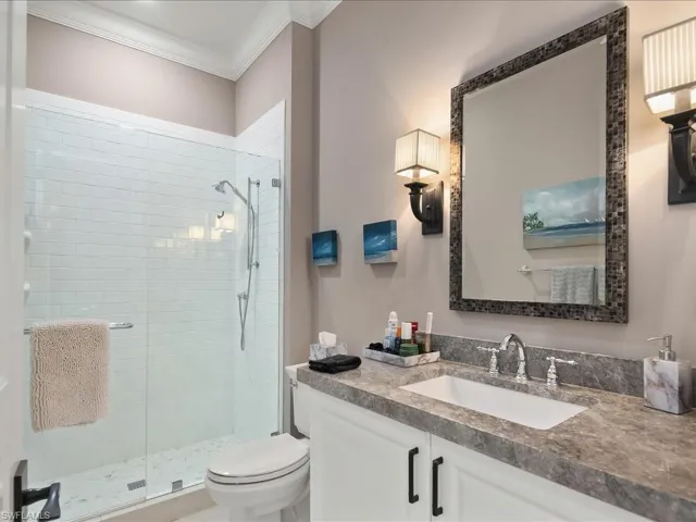 Plush ensuite bathroom with walk in shower and lovely lighting.