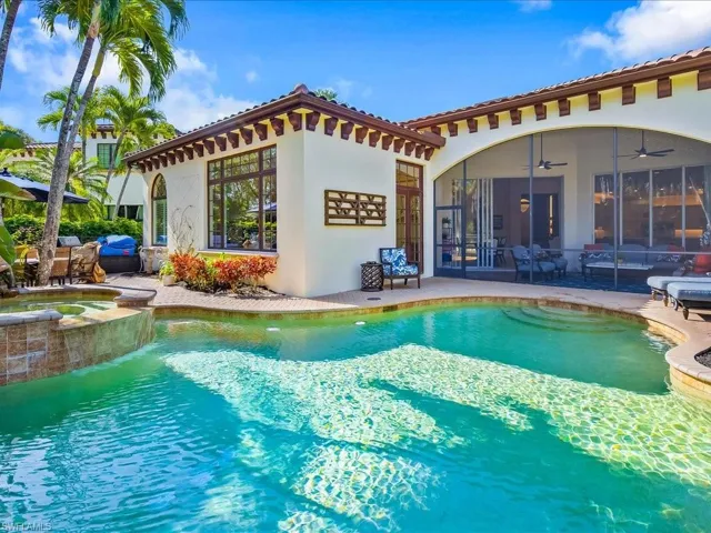 Heated pool and spa with large patio, dining area and lounge chairs.