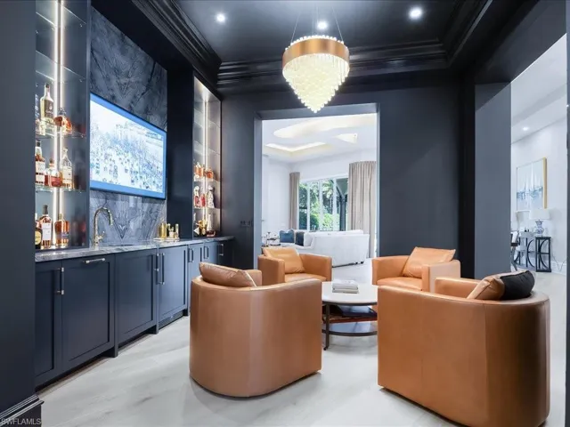 Custom bar/cocktails room with dramatic lighting, icemaker and wine refrigerator.