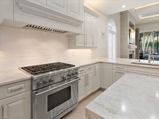 Wolff Gas range with custom hood.  Leathered Taj Mahal Quartzite countertops