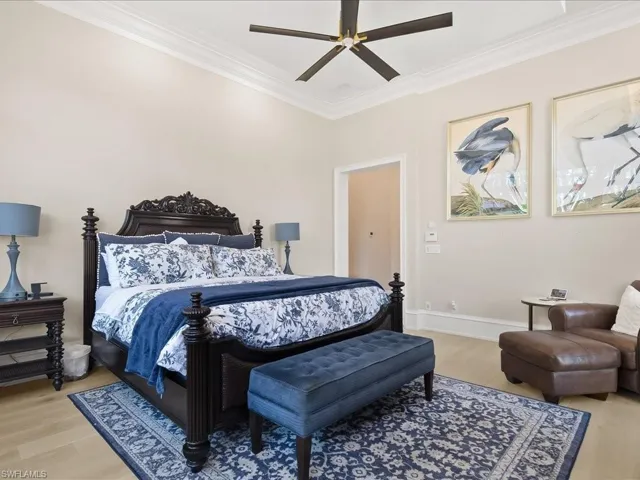 Primary bedroom suite with french doors to the pool and lovely views of the landscaping and waterfalls and European White Oak wood flooring.