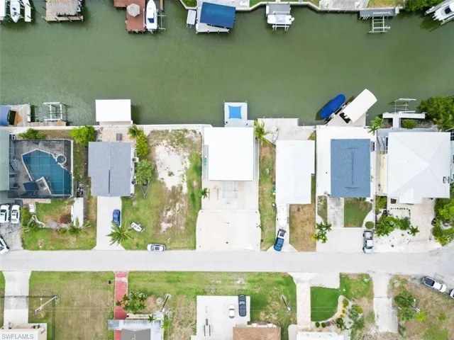 Aerial view of residential area featuring a nearby body of water