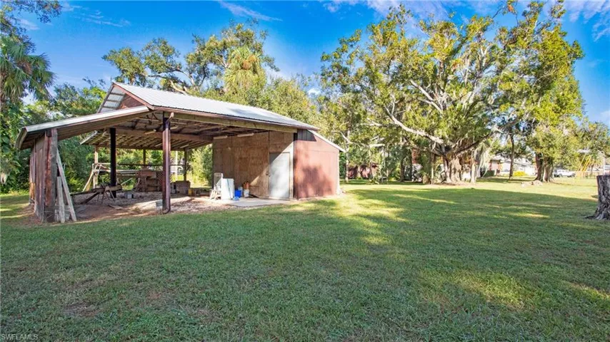 3 stall pole barn with additional enclosed space perfect to lock up tools and other equipment. Has water, power and camper hookup.