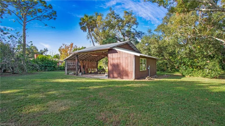 3 stall pole barn with additional enclosed space perfect to lock up tools and other equipment. Has water, power and camper hookup.