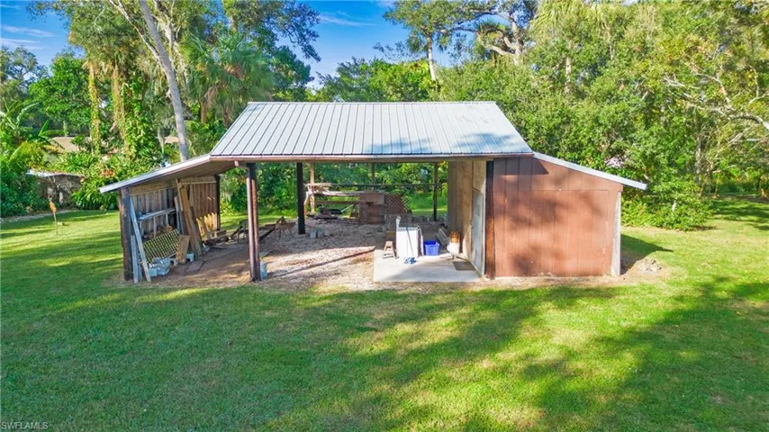 3 stall pole barn with additional enclosed space perfect to lock up tools and other equipment. Has water, power and camper hookup.