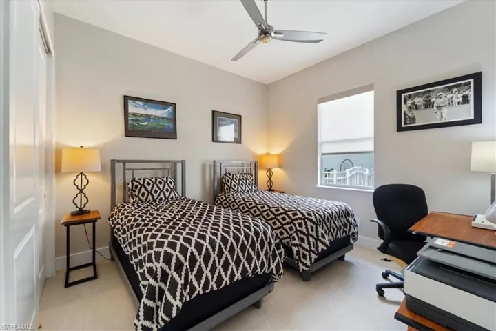 Bedroom featuring an office area and ceiling fan