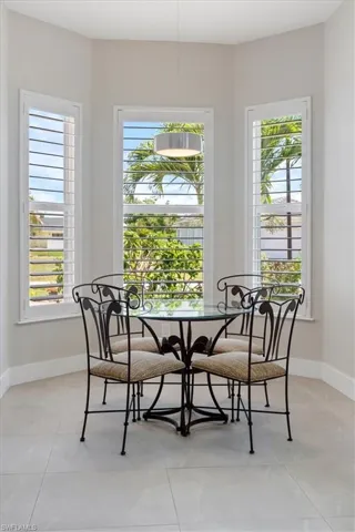 Dining room featuring baseboards and light tile patterned flooring