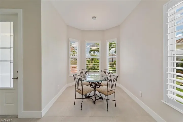 Dining space with baseboards and light tile patterned floors