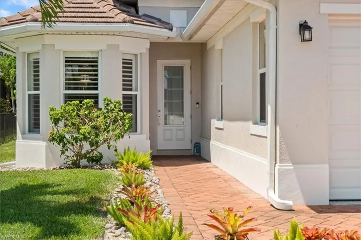 Entrance to property with stucco siding