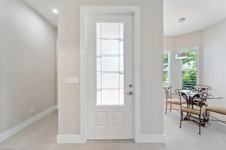 Entrance foyer with baseboards and light tile patterned floors