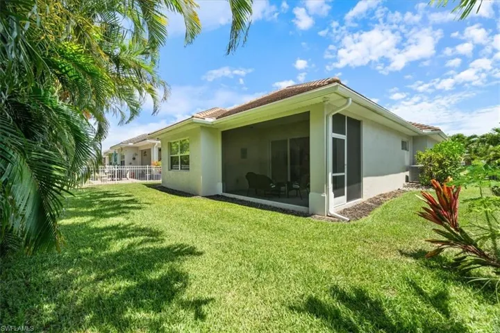 Back of house featuring stucco siding and a sunroom