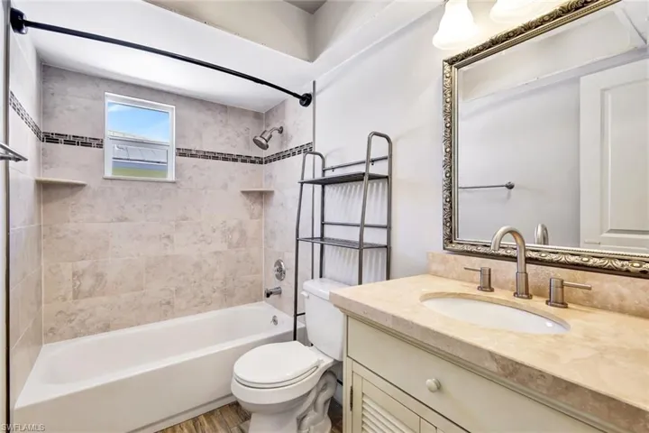 Bathroom featuring vanity and washtub / shower combination