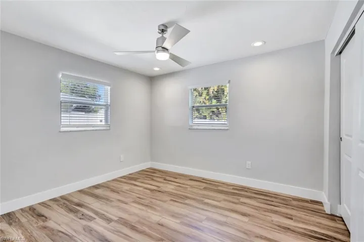 Unfurnished bedroom featuring a closet, light wood-style floors, ceiling fan, and recessed lighting