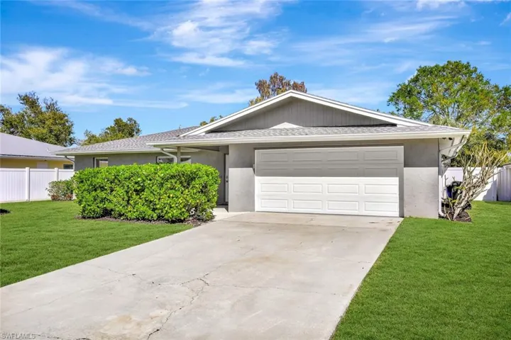 Single story home featuring stucco siding, concrete driveway, an attached garage, and roof with shingles