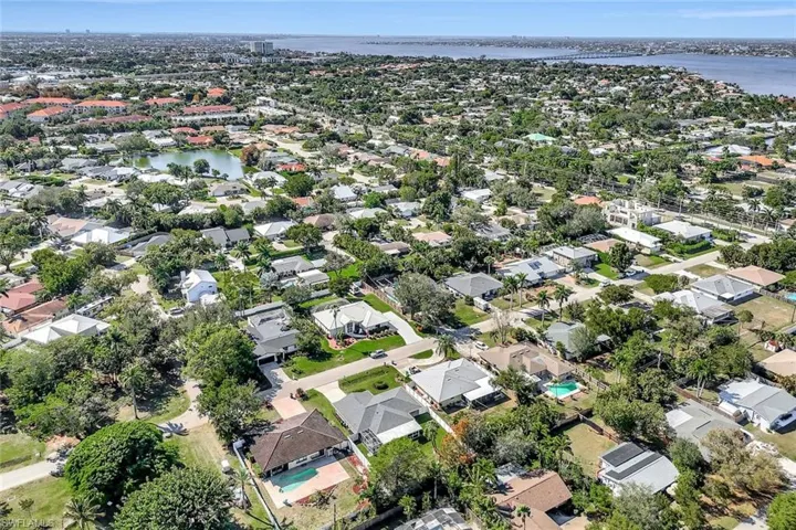 Aerial overview of property's location with a large body of water and nearby suburban area