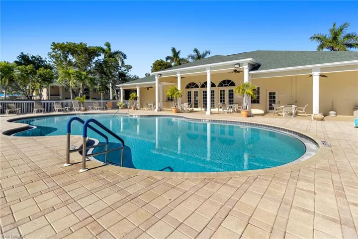 Pool with ceiling fan, french doors, a patio area, and fence