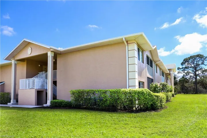View of property exterior with a yard and stucco siding