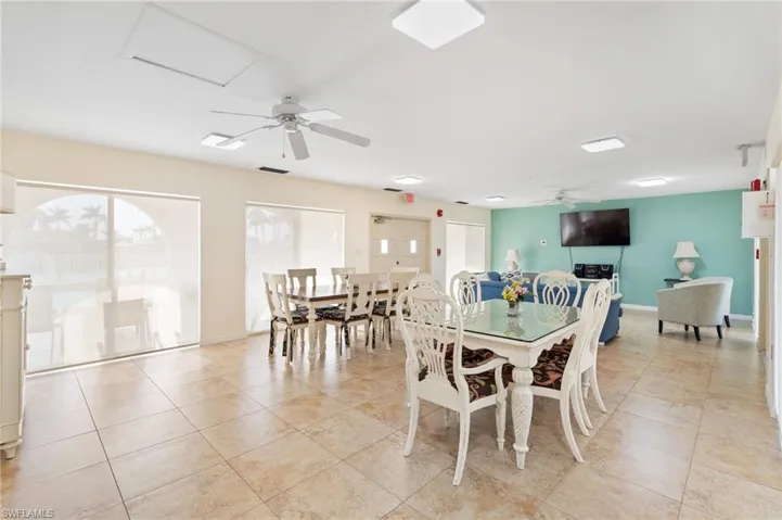 Community room with Tiled dining space with ceiling fan