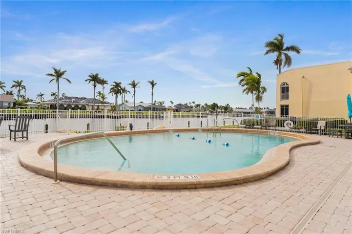 View of swimming pool with a patio area and a great water view