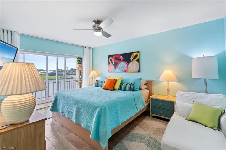Bedroom featuring hardwood / wood-style flooring, access to lanai with gorgeous view.