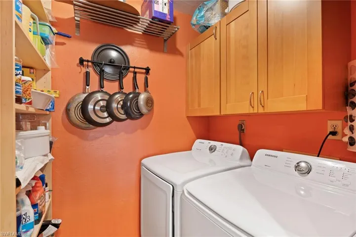 Laundry room with extra cabinets and washer and dryer