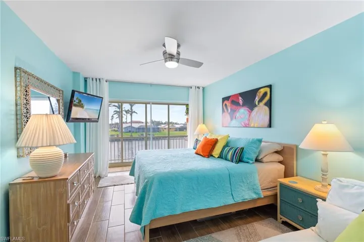 Bedroom featuring ceiling fan and access to lanai.