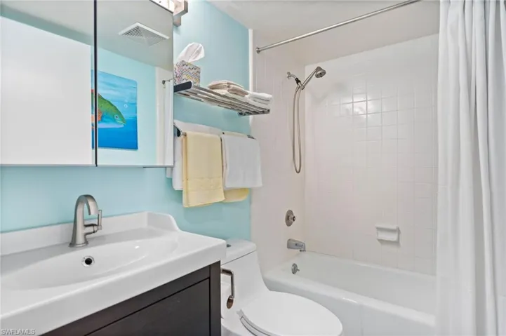 Guest, Full bathroom with toilet, vanity, and shower / tub combo