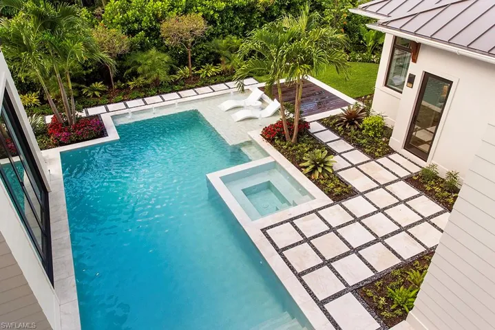 View of pool featuring a pool with connected hot tub and a patio