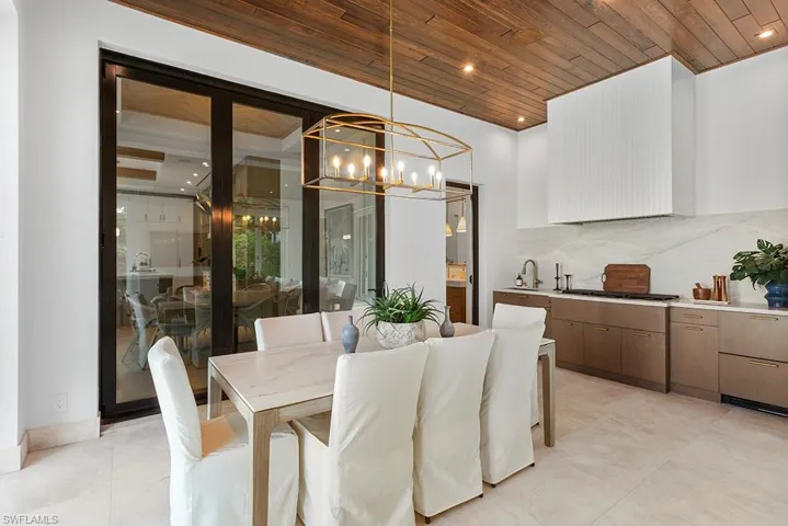 Dining space featuring wooden ceiling, a chandelier, and light tile patterned flooring