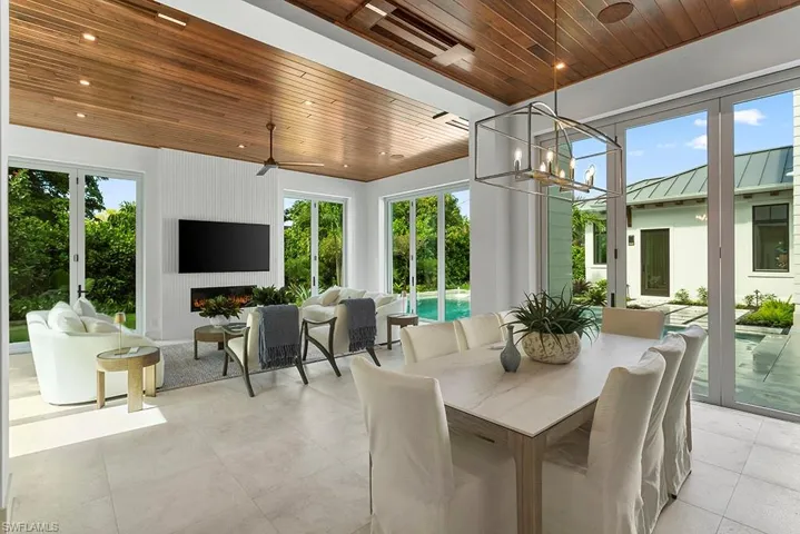 Sunroom / solarium with french doors and a chandelier