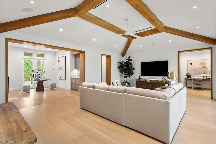 Living room featuring ceiling fan, baseboards, recessed lighting, and light wood-style floors