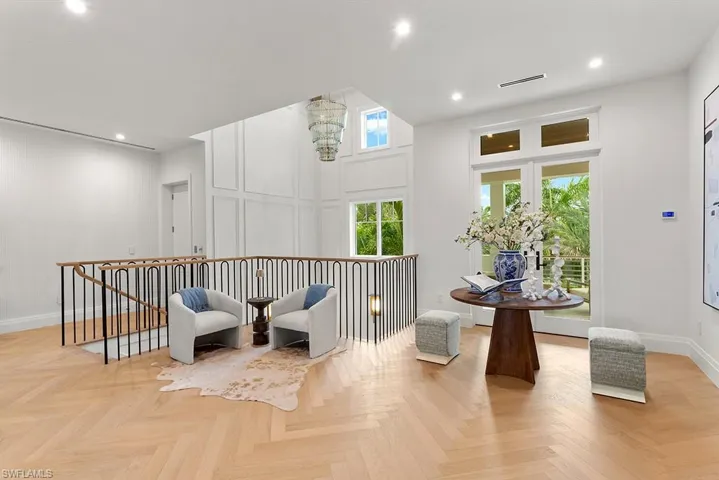 Sitting room featuring baseboards, an upstairs landing, and recessed lighting