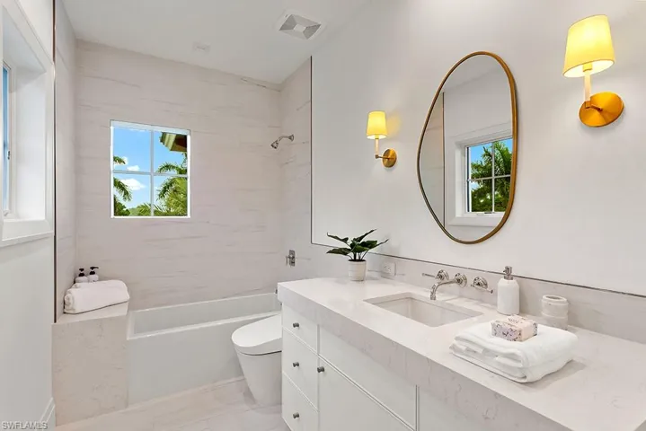 Full bathroom with vanity, toilet, and washtub / shower combination