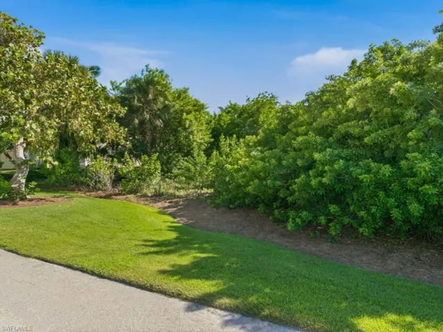 Expansive lot featuring manicured lawn and mature vegetation