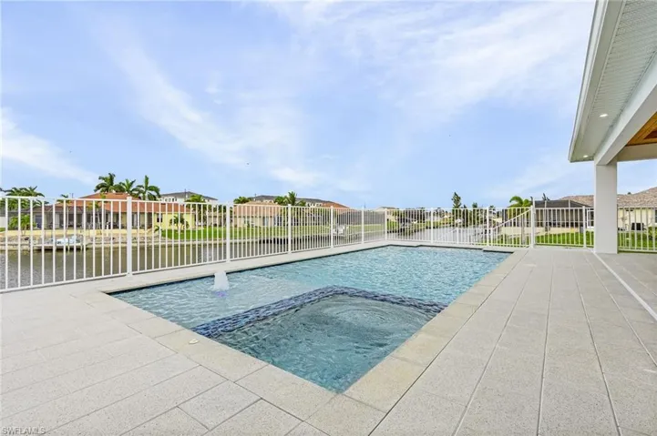 View of swimming pool featuring an in ground hot tub and a patio