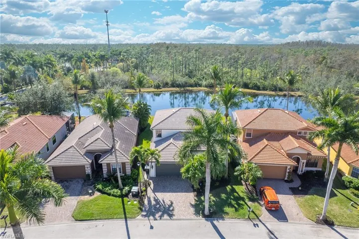 Aerial view of residential area featuring a nearby body of water