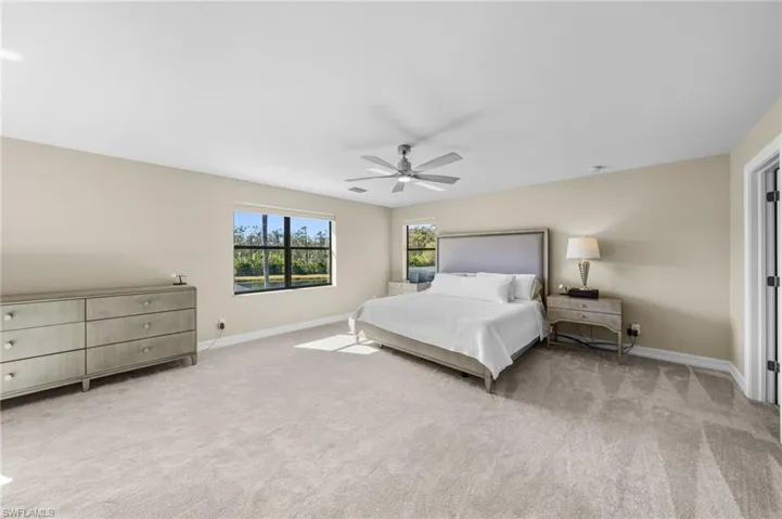 Bedroom with light carpet and ceiling fan