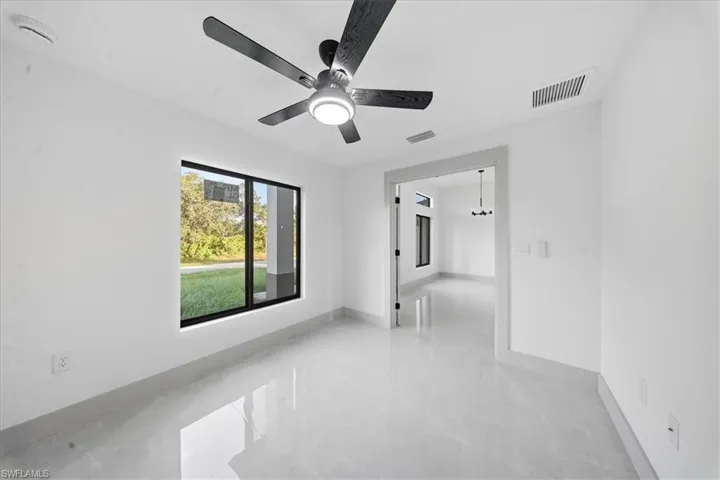 Spare room featuring ceiling fan and baseboards