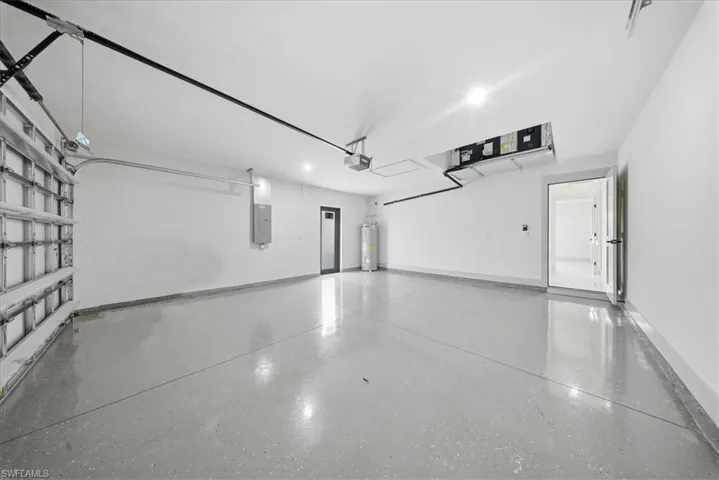 Garage with water heater and electric panel