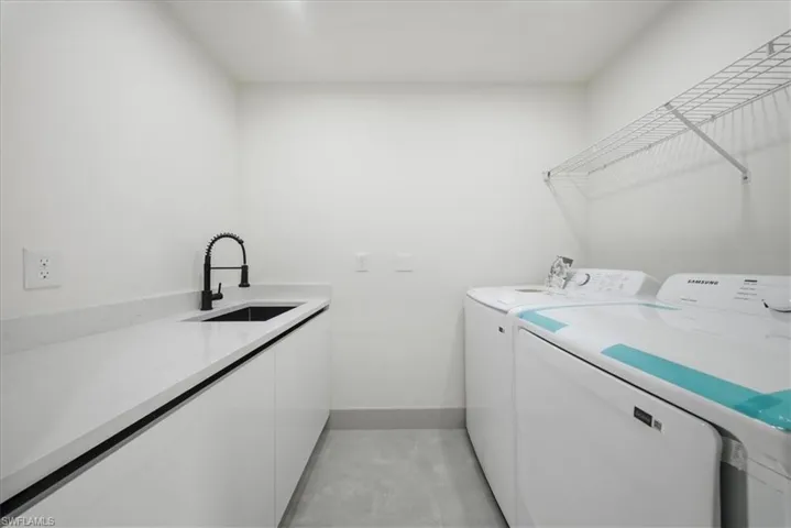 Laundry area featuring a sink and washing machine and dryer
