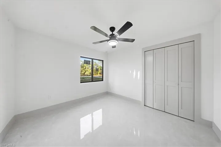 Unfurnished bedroom featuring a closet and a ceiling fan