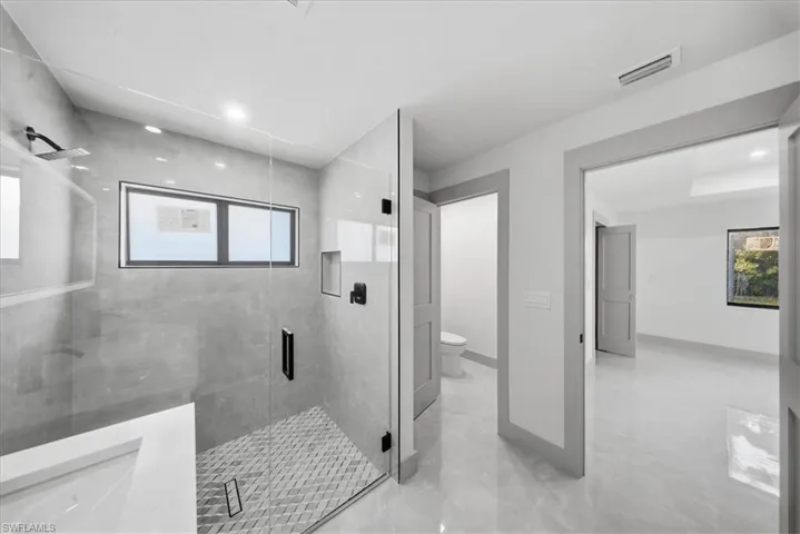 Full bathroom with a stall shower and recessed lighting