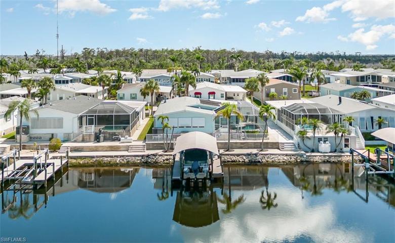 Rear view of dock, lift, and pool
