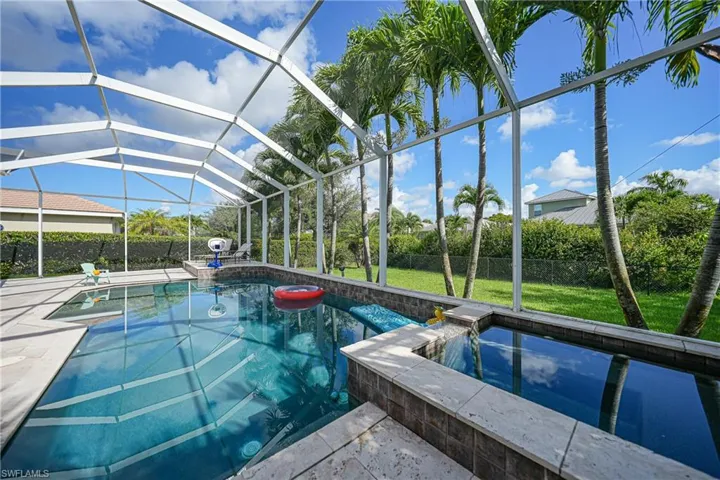 A Crown of Spectacular Palms Accents the Pool & Spa