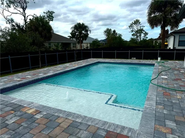 View of pool with a fenced backyard and a patio area
