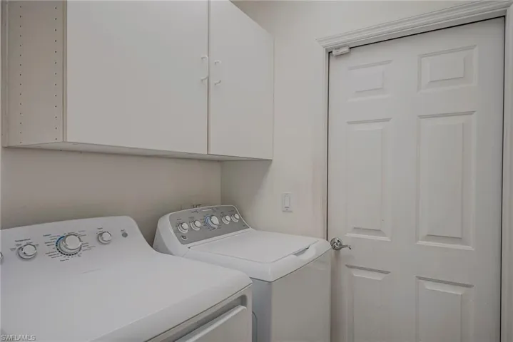 Laundry room featuring washing machine and dryer and cabinet space