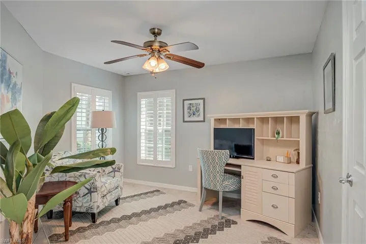 Office space featuring baseboards and ceiling fan