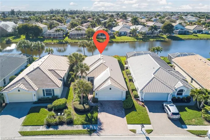 Aerial perspective of suburban area featuring a nearby body of water
